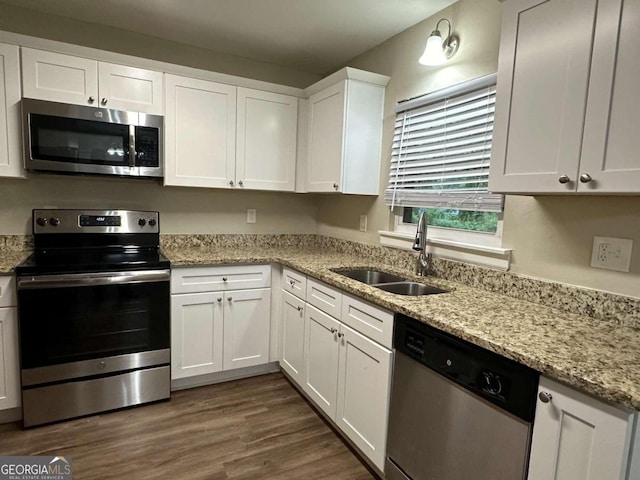 3188 Convair Ln, Decatur, GA 30032 - kitchen with a sink, stainless steel appliances, white cabinets, light stone countertops, and dark wood-type flooring