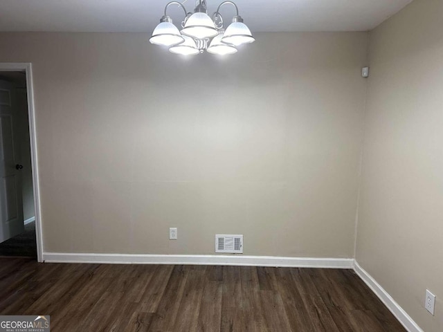 3188 Convair Ln, Decatur, GA 30032 - unfurnished dining area featuring dark wood-type flooring, a chandelier, visible vents, and baseboards
