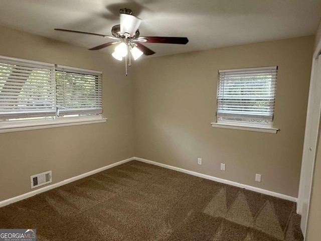 unfurnished room with ceiling fan and carpet