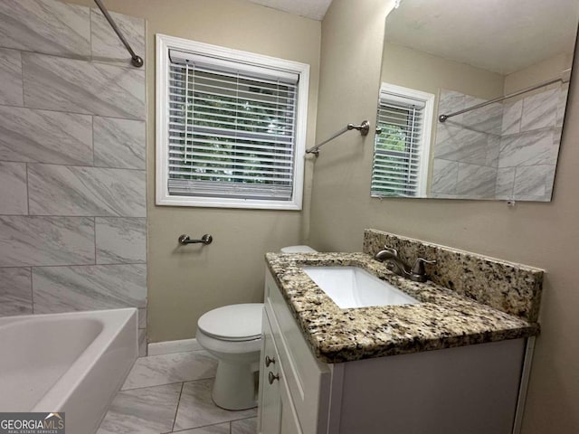 full bathroom with tiled shower / bath, vanity, and toilet