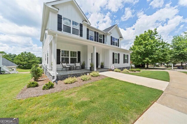 view of front of house featuring a front yard and covered porch