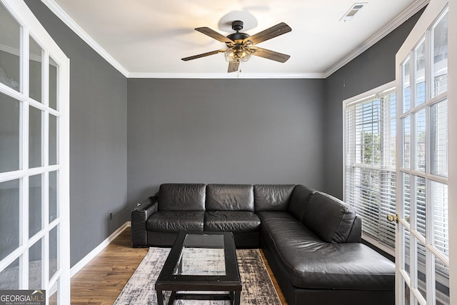 living room featuring ceiling fan, french doors, ornamental molding, and hardwood / wood-style flooring