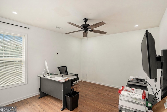 office space with ceiling fan and dark hardwood / wood-style flooring