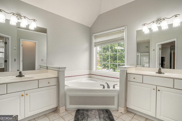 bathroom featuring tile patterned flooring, vanity, and vaulted ceiling