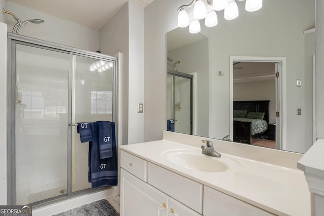 bathroom featuring tile patterned flooring, vanity, and an enclosed shower