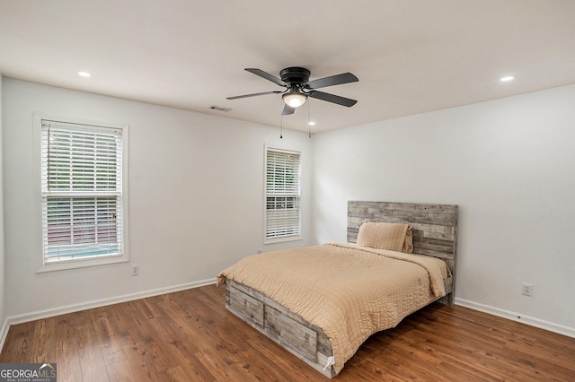 bedroom featuring ceiling fan and dark hardwood / wood-style flooring