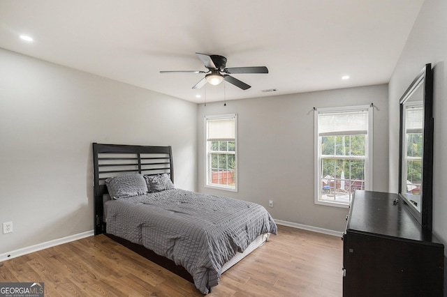 bedroom with ceiling fan and light hardwood / wood-style floors