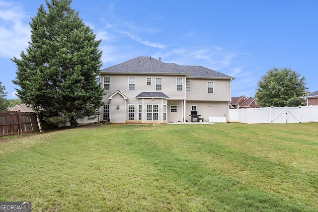 back of property featuring a yard and a patio