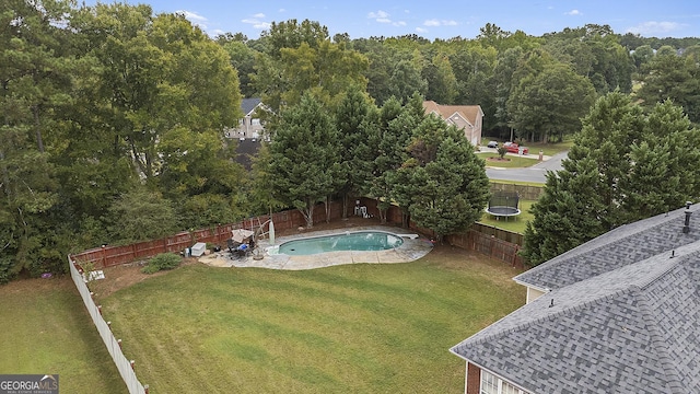 view of pool featuring a lawn and a patio area