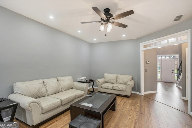 living room with light wood-type flooring and ceiling fan