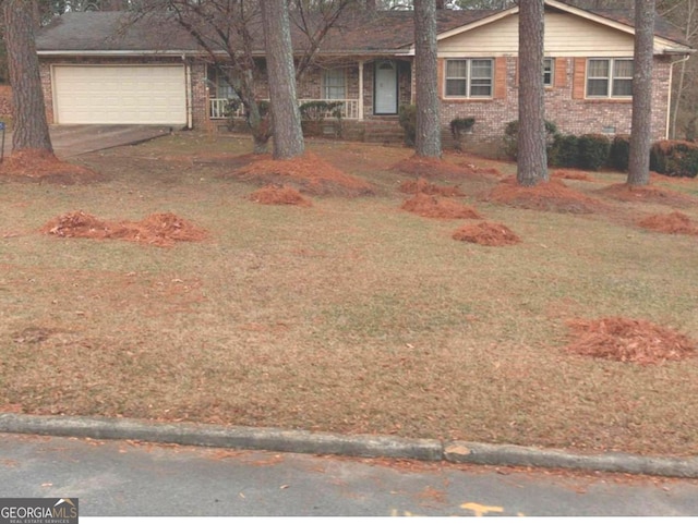 view of front of home featuring a garage and a front lawn