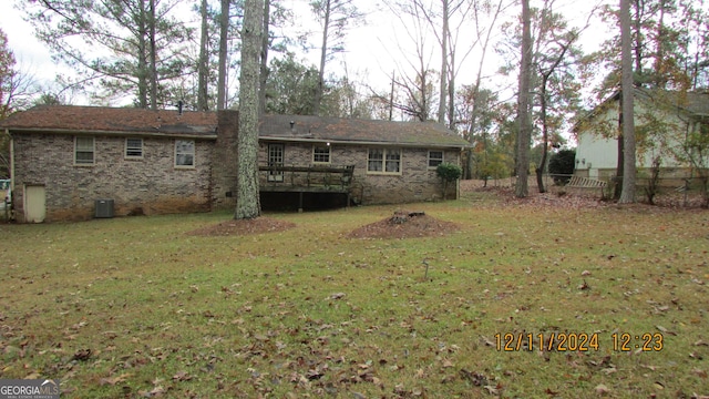 rear view of property with a yard