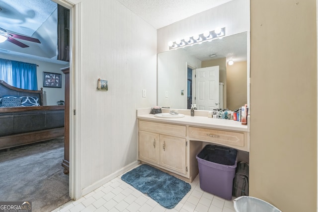 bathroom featuring a textured ceiling, vanity, ceiling fan, and tile patterned flooring