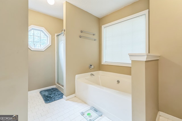 bathroom with shower with separate bathtub, a textured ceiling, and tile patterned floors