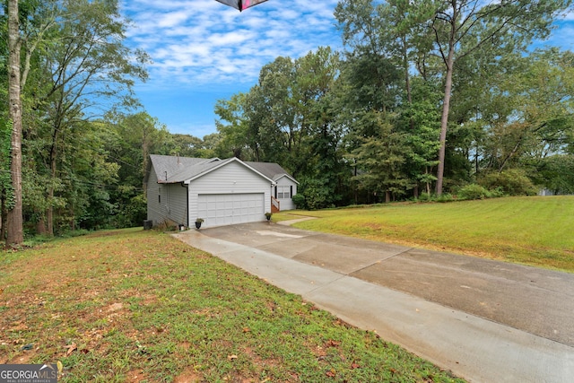 view of front of property with a garage and a front lawn