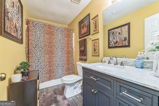 bathroom with toilet, hardwood / wood-style floors, vanity, a textured ceiling, and a shower with curtain