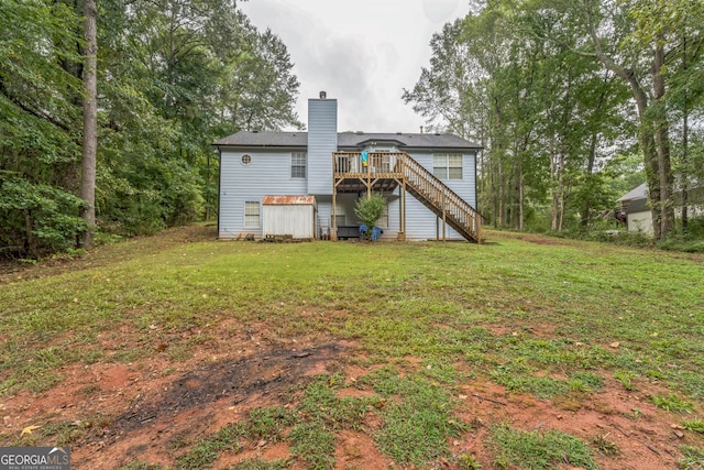 rear view of property with a yard and a wooden deck