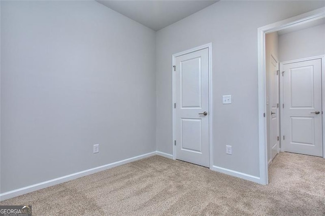 unfurnished bedroom with light carpet