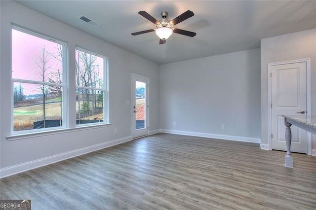 unfurnished room with ceiling fan and wood-type flooring