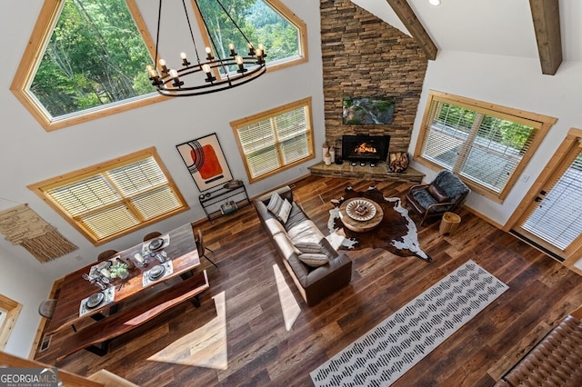 living room with a wealth of natural light, dark hardwood / wood-style flooring, and high vaulted ceiling