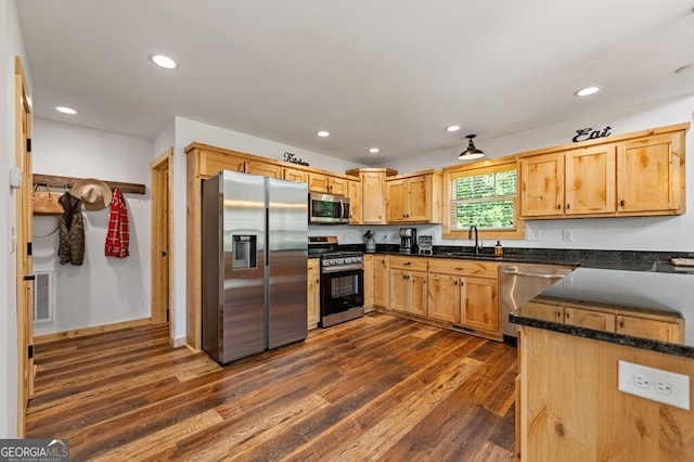 kitchen featuring stainless steel appliances, dark wood-type flooring, and sink