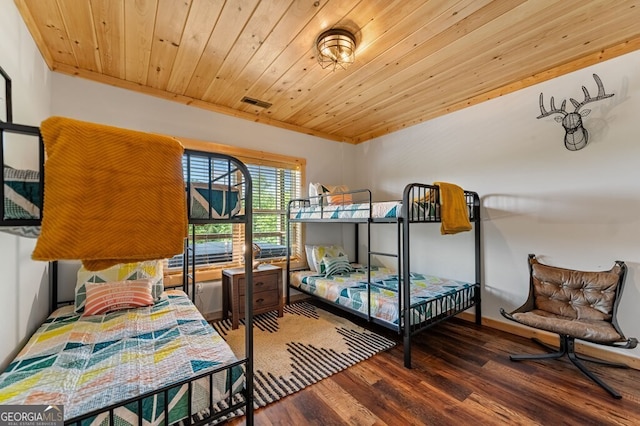 bedroom with dark hardwood / wood-style flooring and wood ceiling