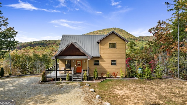 view of front of property with a mountain view and a porch