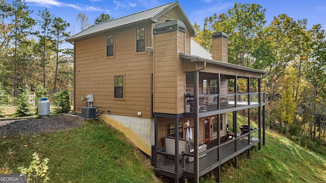 view of side of property featuring a sunroom and a yard