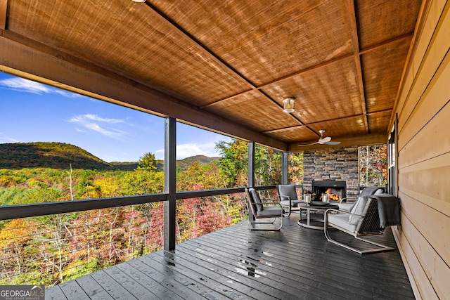 unfurnished sunroom with a mountain view and wood ceiling