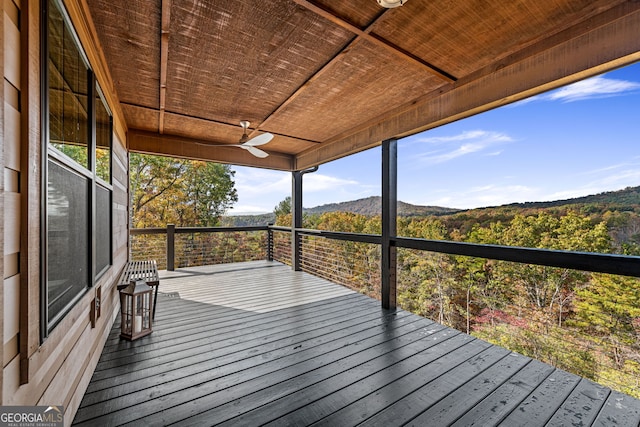 wooden deck with a mountain view and ceiling fan