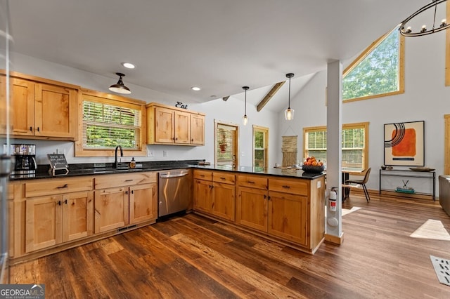 kitchen with dark hardwood / wood-style flooring, stainless steel dishwasher, kitchen peninsula, lofted ceiling, and decorative light fixtures