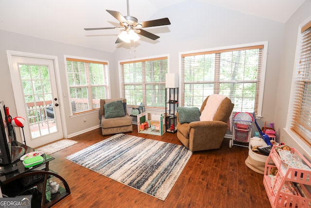 living area featuring lofted ceiling, ceiling fan, and dark hardwood / wood-style floors