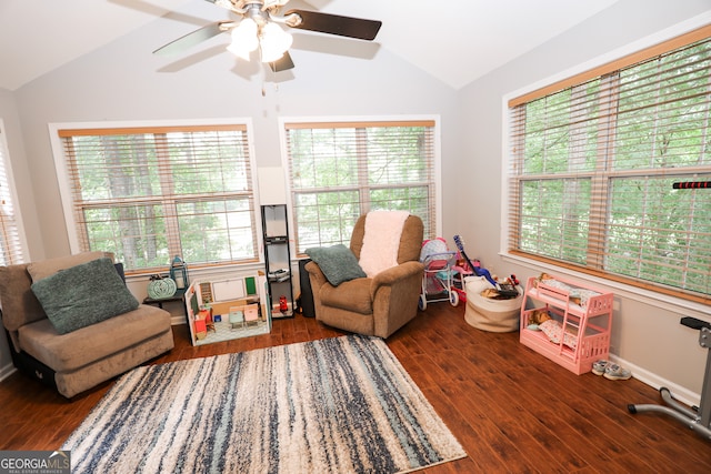 living area with lofted ceiling, dark wood-type flooring, ceiling fan, and a wealth of natural light