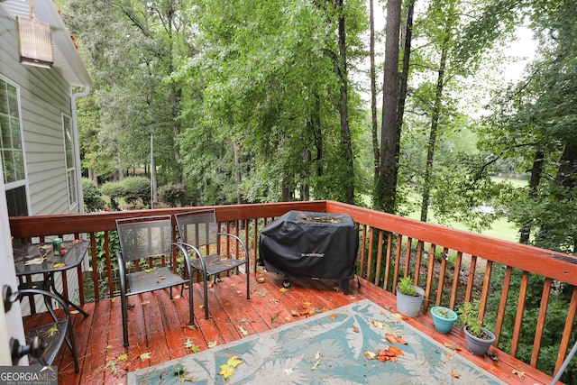 wooden terrace featuring a grill