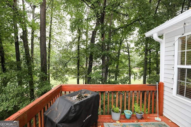 wooden terrace featuring a grill