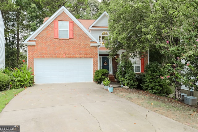 view of front of home featuring cooling unit and a garage