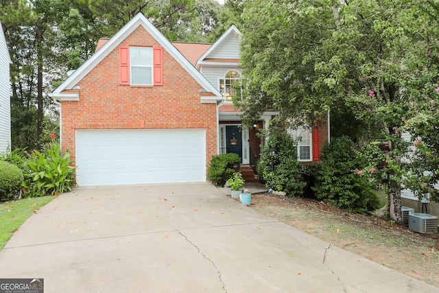 traditional home featuring brick siding, driveway, and a garage
