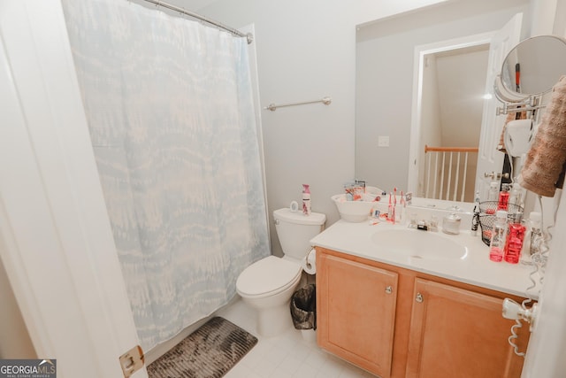 bathroom featuring toilet, vanity, and curtained shower