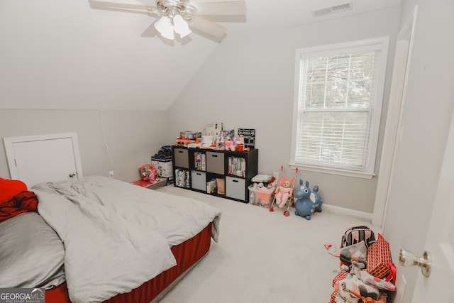 bedroom with multiple windows, ceiling fan, vaulted ceiling, and carpet floors