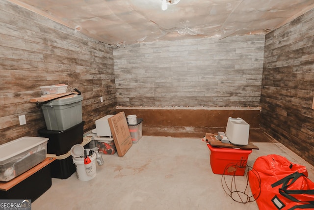 interior space featuring concrete floors and wood walls