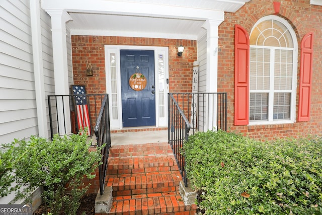 property entrance featuring brick siding