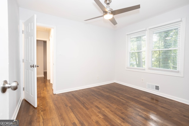 spare room with ceiling fan and dark hardwood / wood-style floors