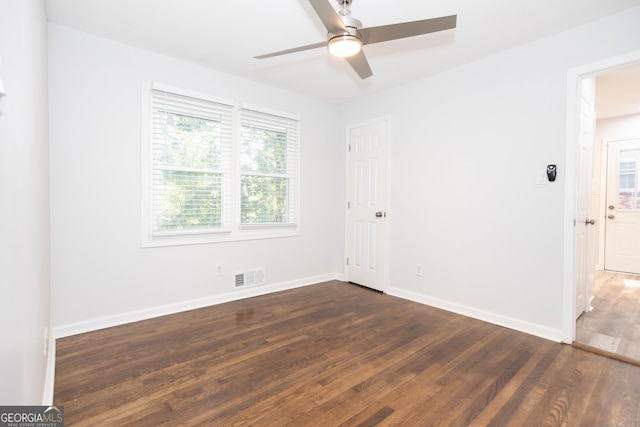 spare room with ceiling fan and dark hardwood / wood-style floors