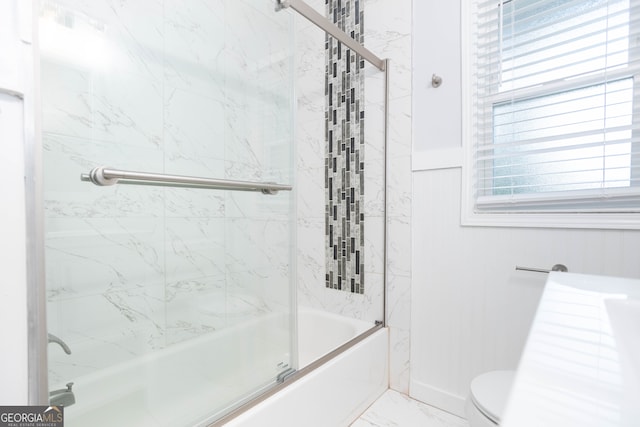 bathroom with enclosed tub / shower combo and toilet