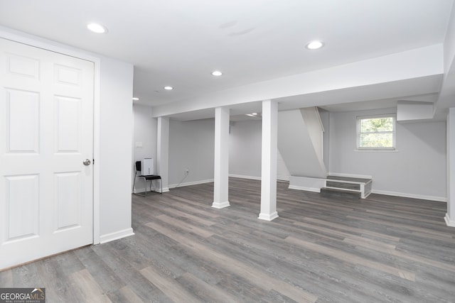 basement featuring dark hardwood / wood-style flooring