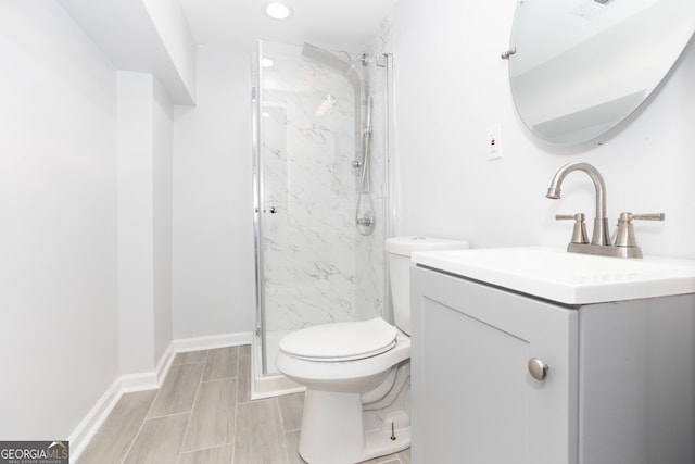 bathroom with walk in shower, vanity, and toilet