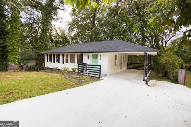 ranch-style house featuring a front yard, a porch, and a carport