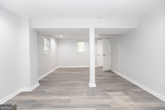 basement with light hardwood / wood-style flooring