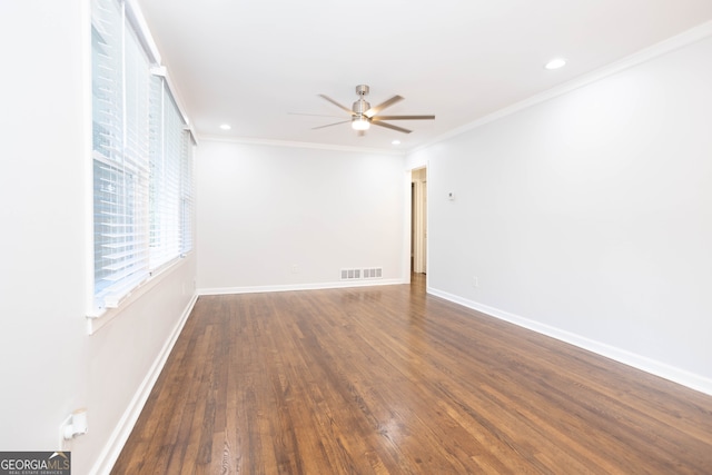 empty room featuring ceiling fan, dark hardwood / wood-style floors, and crown molding