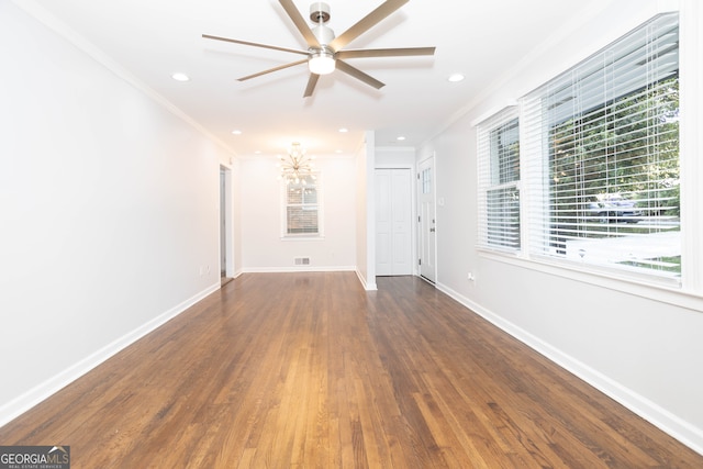 unfurnished living room with crown molding, dark hardwood / wood-style flooring, and ceiling fan